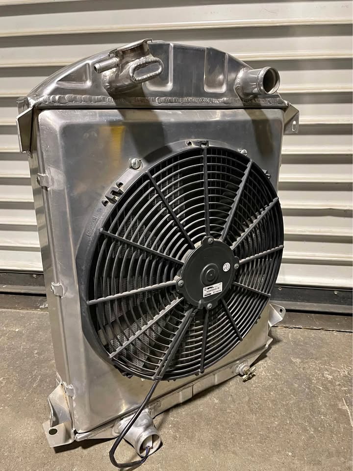 Hot Rod aluminum Radiator with Spal electric fan made by US Radiator 32 & 1” shorter than stock.