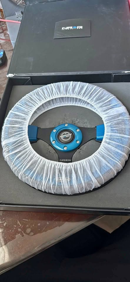 NRG innovations Learher steering wheel with blue inserts.